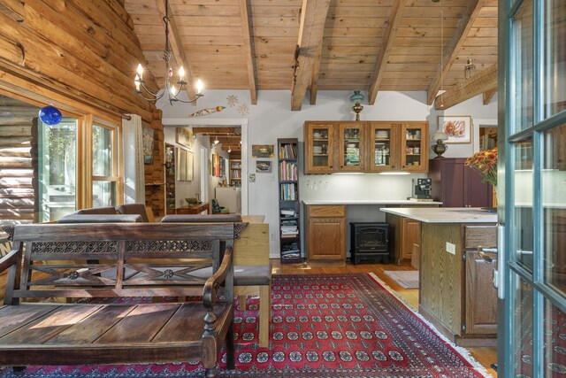 17 Spruce Meadow Ln, Jefferson, ME 04348 - kitchen with wood ceiling, brown cabinets, light countertops, a wood stove, and a chandelier