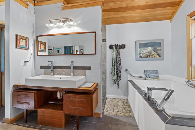17 Spruce Meadow Ln, Jefferson, ME 04348 - bathroom featuring a bath, vanity, and baseboards