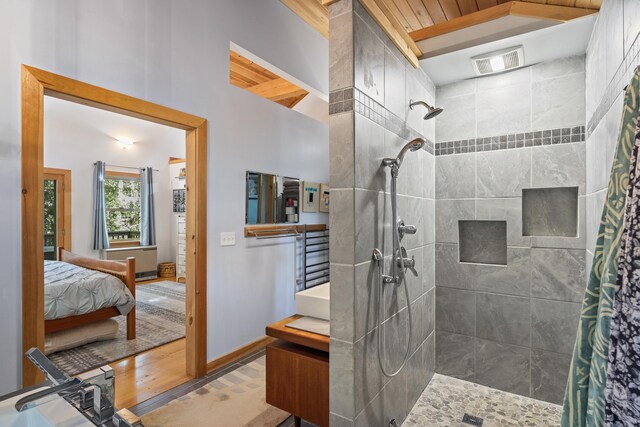 17 Spruce Meadow Ln, Jefferson, ME 04348 - ensuite bathroom with a tile shower, wood finished floors, and baseboards
