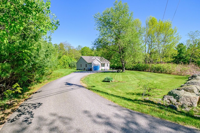 175 Lake House Rd, Naples, ME 04055 - view of front of home with asphalt driveway, a front yard, and a forest view