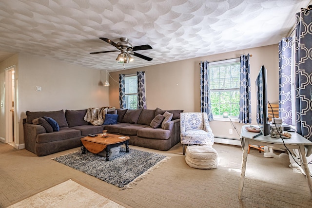 175 Lake House Rd, Naples, ME 04055 - living area with ceiling fan, a baseboard radiator, baseboards, and carpet