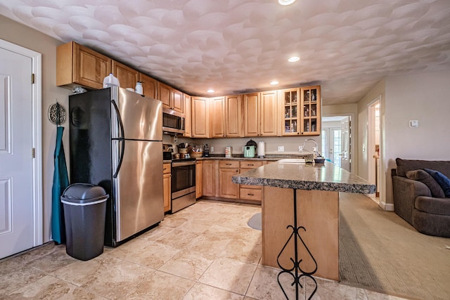 175 Lake House Rd, Naples, ME 04055 - kitchen with stainless steel appliances, a sink, dark countertops, glass insert cabinets, and recessed lighting
