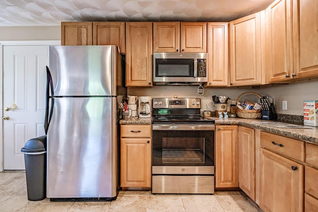 175 Lake House Rd, Naples, ME 04055 - kitchen with appliances with stainless steel finishes, dark stone counters, and light brown cabinets