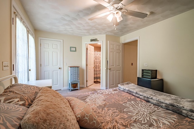 175 Lake House Rd, Naples, ME 04055 - bedroom with light carpet, a ceiling fan, baseboards, and ensuite bathroom
