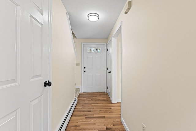 162 Beach St Unit 4, Saco, ME 04072 - hallway featuring light wood-type flooring, a baseboard heating unit, and baseboards