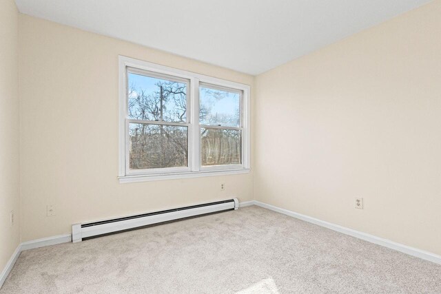 162 Beach St Unit 4, Saco, ME 04072 - empty room with a baseboard heating unit, carpet floors, and baseboards