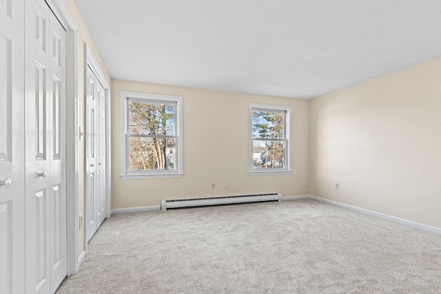 162 Beach St Unit 4, Saco, ME 04072 - unfurnished bedroom featuring baseboard heating, multiple windows, carpet floors, and baseboards