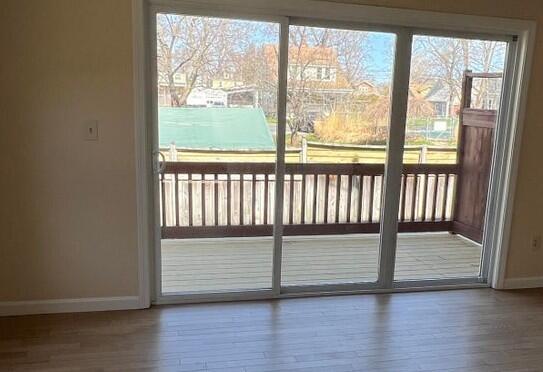 162 Beach St Unit 4, Saco, ME 04072 - entryway with baseboards, wood finished floors, and healthy amount of natural light