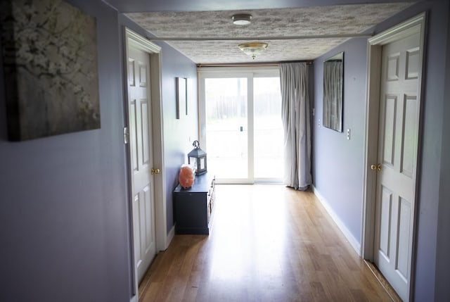 15 Lucille St, Saco, ME 04072 - hallway featuring light wood-style flooring and baseboards