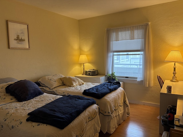31 Ocean Ave Unit 105, York, ME 03909 - bedroom with wood finished floors, a textured wall, and baseboards