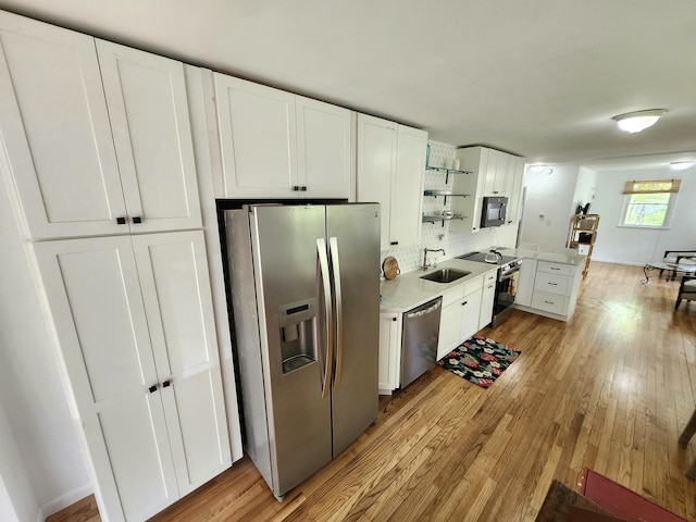 567 Ossipee Trl W, Standish, ME 04084 - kitchen with appliances with stainless steel finishes, a sink, light wood-type flooring, and open shelves