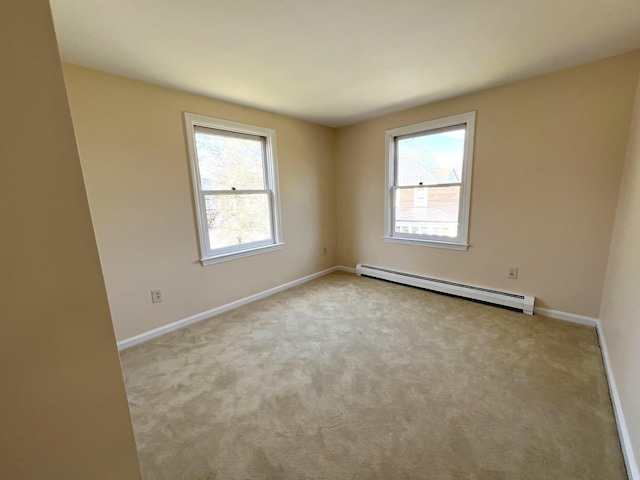 162 Beach St Unit 3, Saco, ME 04072 - carpeted empty room featuring a baseboard heating unit, plenty of natural light, and baseboards