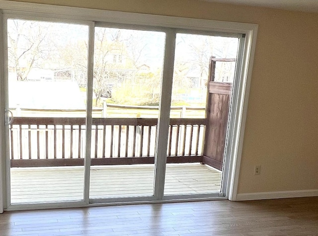 162 Beach St Unit 3, Saco, ME 04072 - doorway to outside with plenty of natural light, baseboards, and wood finished floors