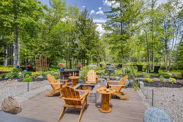4 Dragonfly Cir, Limerick, ME 04048 - view of patio / terrace with an outdoor fire pit, view of scattered trees, and a deck