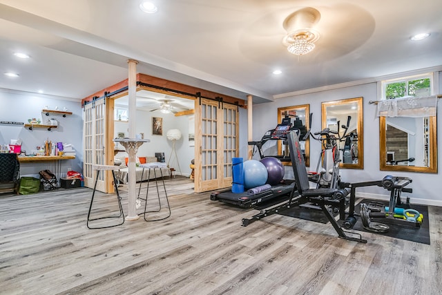 4 Dragonfly Cir, Limerick, ME 04048 - workout room with a barn door, wood finished floors, crown molding, recessed lighting, and baseboards