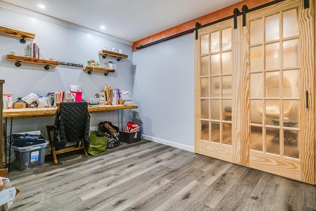 4 Dragonfly Cir, Limerick, ME 04048 - home office with wood finished floors, a barn door, ornamental molding, and baseboards