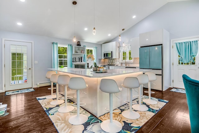 4 Dragonfly Cir, Limerick, ME 04048 - kitchen featuring freestanding refrigerator, stainless steel microwave, white cabinetry, a breakfast bar, and recessed lighting