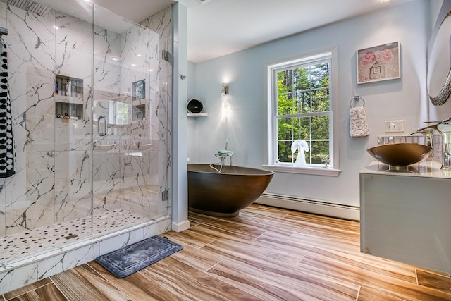 4 Dragonfly Cir, Limerick, ME 04048 - bathroom with a freestanding bath, a marble finish shower, a baseboard radiator, vanity, and wood finished floors