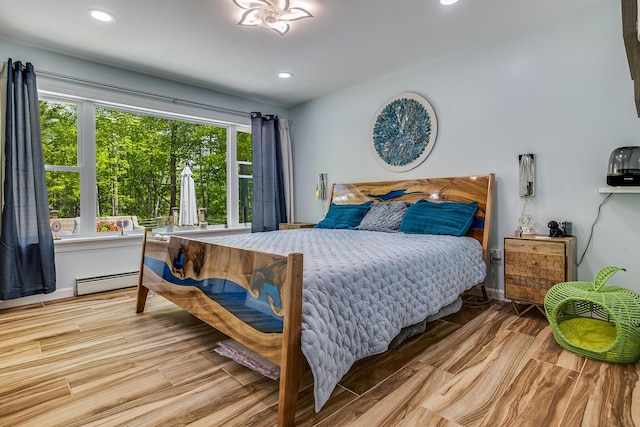 4 Dragonfly Cir, Limerick, ME 04048 - bedroom with a baseboard radiator, multiple windows, wood finished floors, and recessed lighting
