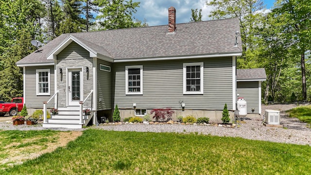 4 Dragonfly Cir, Limerick, ME 04048 - view of front of home with a front yard, roof with shingles, and a chimney