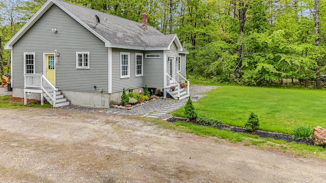 4 Dragonfly Cir, Limerick, ME 04048 - view of front facade featuring a chimney, roof with shingles, a front lawn, and entry steps