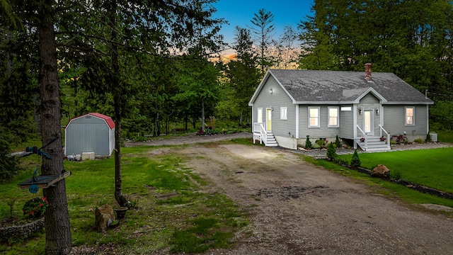 4 Dragonfly Cir, Limerick, ME 04048 - view of front facade featuring a shingled roof, a front yard, entry steps, and driveway