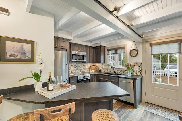 13 Ledge Rd Unit 3, Ogunquit, ME 03907 - kitchen featuring stainless steel appliances, a sink, dark countertops, dark brown cabinets, and wood finished floors