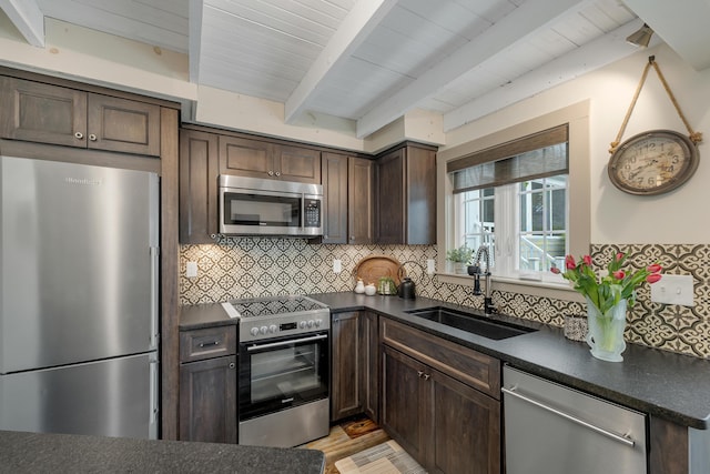 13 Ledge Rd Unit 3, Ogunquit, ME 03907 - kitchen featuring stainless steel appliances, a sink, dark countertops, dark brown cabinets, and wood ceiling with exposed beams