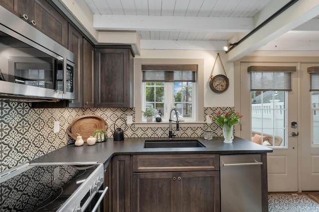 13 Ledge Rd Unit 3, Ogunquit, ME 03907 - kitchen featuring appliances with stainless steel finishes, a sink, dark brown cabinets, dark countertops, and wood ceiling with exposed beams