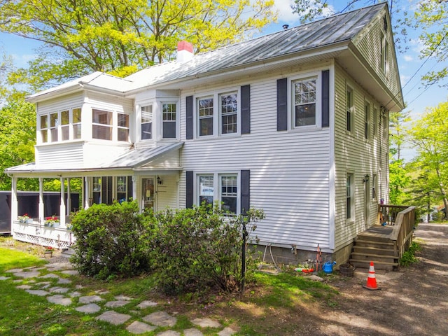 103 Taylor Woods Rd, Belgrade, ME 04917 - view of front of home featuring a chimney, a metal roof, and a standing seam roof