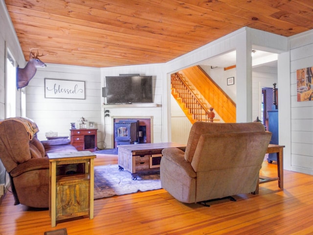 103 Taylor Woods Rd, Belgrade, ME 04917 - living room with wood ceiling, wood walls, stairway, hardwood / wood-style floors, and a glass covered fireplace