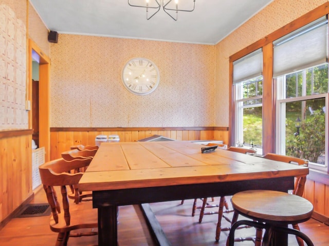 103 Taylor Woods Rd, Belgrade, ME 04917 - dining room with wood finished floors, wooden walls, wainscoting, ornamental molding, and a chandelier