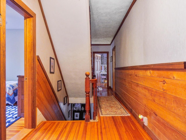 103 Taylor Woods Rd, Belgrade, ME 04917 - hallway with wood finished floors, an upstairs landing, and crown molding