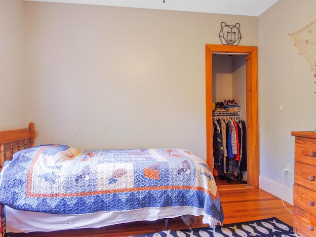 103 Taylor Woods Rd, Belgrade, ME 04917 - bedroom featuring wood finished floors, a walk in closet, and a closet