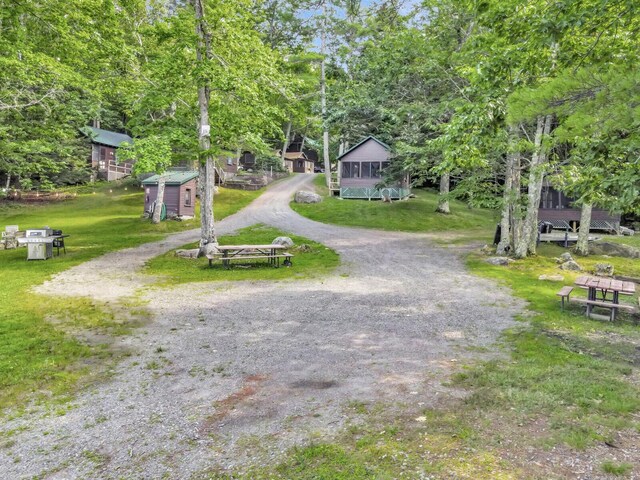 103 Taylor Woods Rd, Belgrade, ME 04917 - view of dirt / gravel driveway with view of wooded area