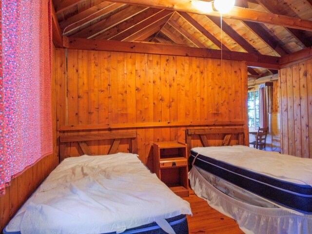103 Taylor Woods Rd, Belgrade, ME 04917 - bedroom featuring wood walls and wood finished floors