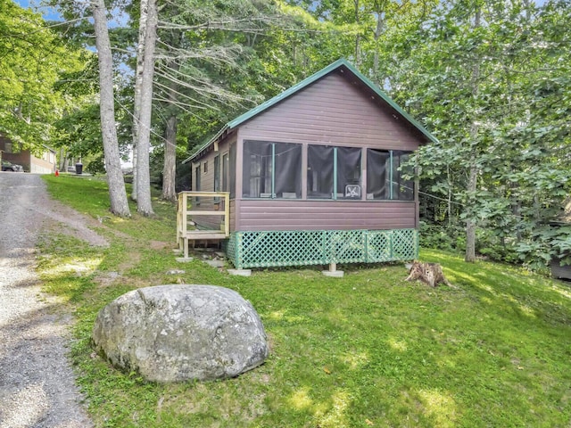 103 Taylor Woods Rd, Belgrade, ME 04917 - back of house featuring a sunroom and a yard
