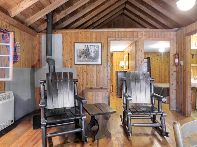 103 Taylor Woods Rd, Belgrade, ME 04917 - sitting room with wood-type flooring, wood walls, heating unit, and a wood stove