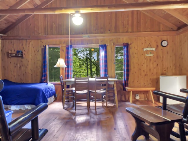 103 Taylor Woods Rd, Belgrade, ME 04917 - bedroom featuring hardwood / wood-style flooring, wood walls, and wooden ceiling