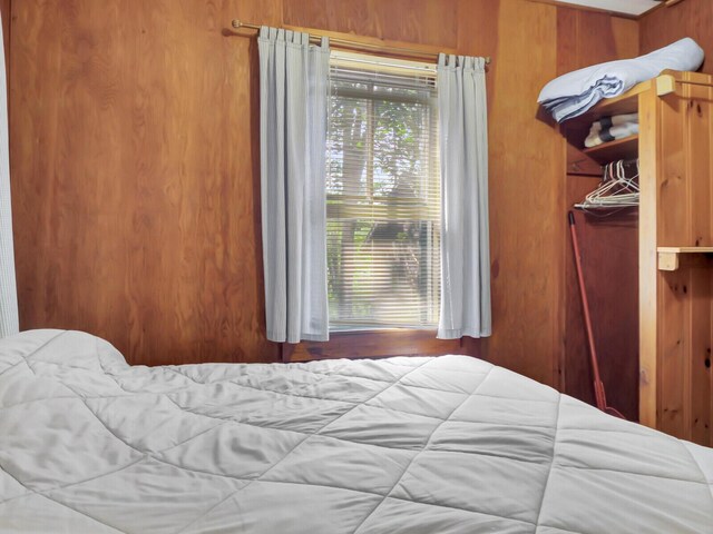 103 Taylor Woods Rd, Belgrade, ME 04917 - bedroom featuring wood walls and a closet