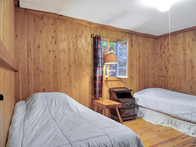 103 Taylor Woods Rd, Belgrade, ME 04917 - bedroom featuring wooden walls and wood finished floors