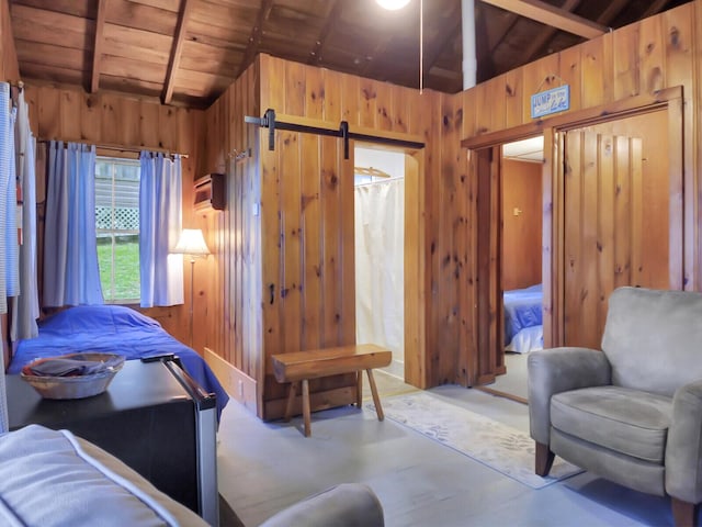 103 Taylor Woods Rd, Belgrade, ME 04917 - bedroom with wooden walls, wood ceiling, and a barn door