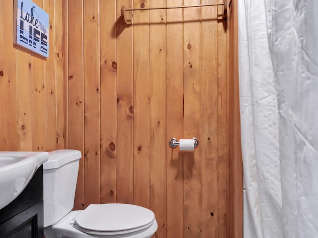 103 Taylor Woods Rd, Belgrade, ME 04917 - full bathroom with wooden walls, a shower with shower curtain, and vanity