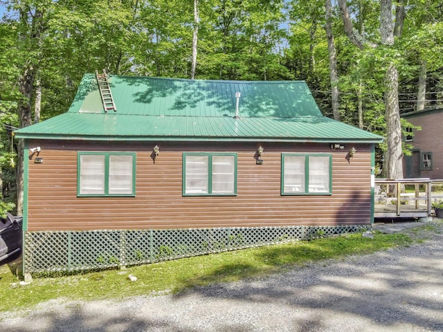103 Taylor Woods Rd, Belgrade, ME 04917 - view of property exterior featuring faux log siding, a deck, and a metal roof