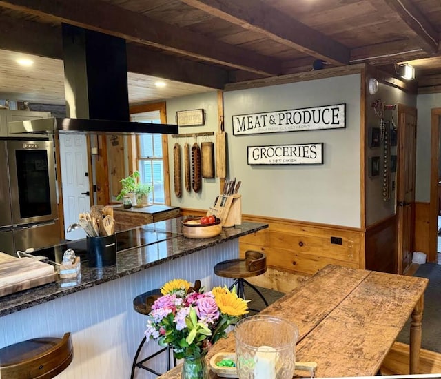 2103 US Highway 1, Sullivan, ME 04664 - kitchen featuring wood ceiling with exposed beams, wooden walls, and a wainscoted wall