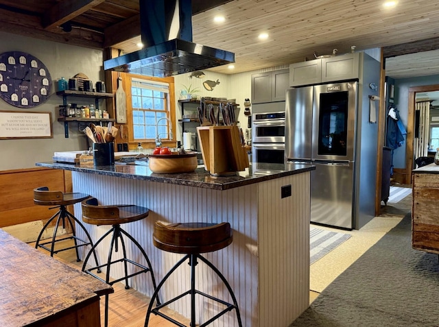 2103 US Highway 1, Sullivan, ME 04664 - kitchen with island exhaust hood, appliances with stainless steel finishes, wooden ceiling, recessed lighting, and a kitchen breakfast bar