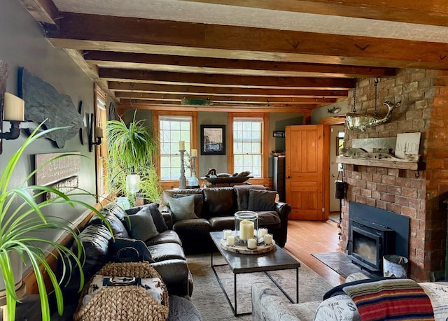 2103 US Highway 1, Sullivan, ME 04664 - living area with light wood-style flooring, beamed ceiling, and a fireplace