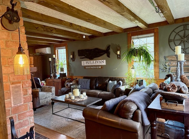 2103 US Highway 1, Sullivan, ME 04664 - living area with beam ceiling, wood finished floors, and a wall unit AC