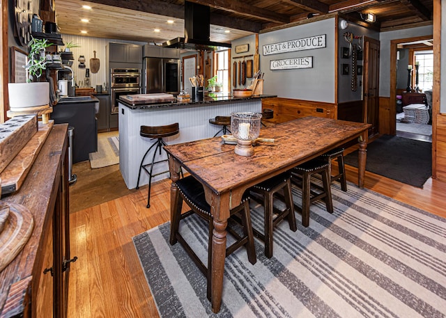 2103 US Highway 1, Sullivan, ME 04664 - dining space with wood ceiling with exposed beams, recessed lighting, a wainscoted wall, and light wood-style floors