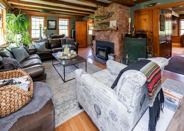 2103 US Highway 1, Sullivan, ME 04664 - living area with wood finished floors, beamed ceiling, and a brick fireplace